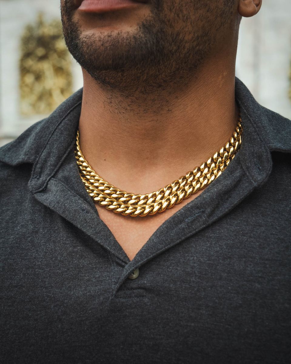 Two 12mm Classic chains stacked, worn over a charcoal polo