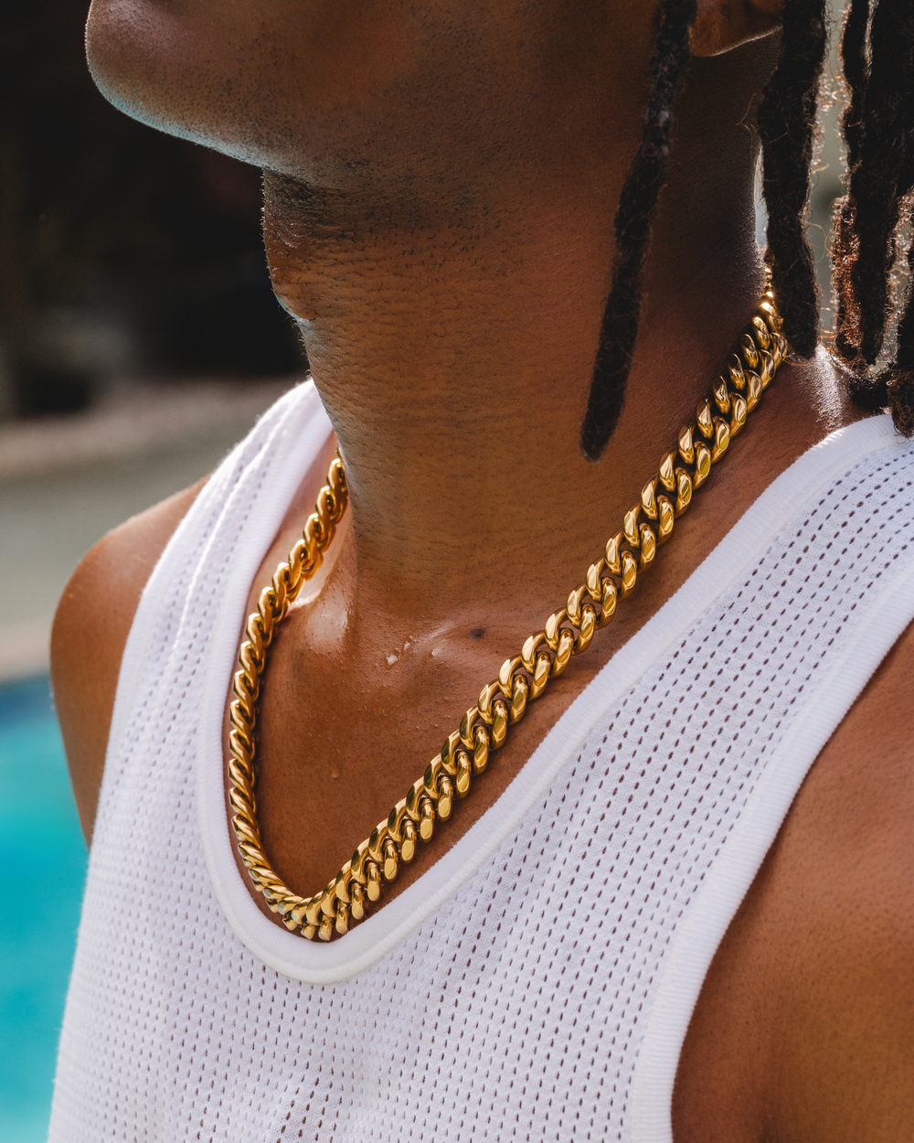 The 12mm Cuban link worn at the collar over a white tank