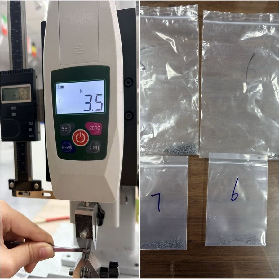 A digital force gauge reading 3.5 newtons with a clasp spring held in its jaws, beside numbered bags of springs